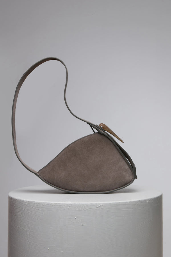 Grey oval shape suede leather handbag with metal accessories