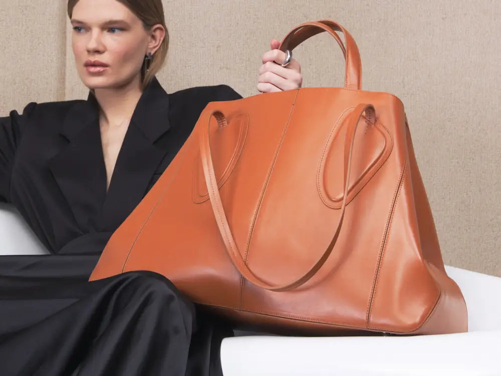 Calf leather maxi non-structured rectangle tote bag with non-removable two leather handle and two leather shoulder strap on a woman
