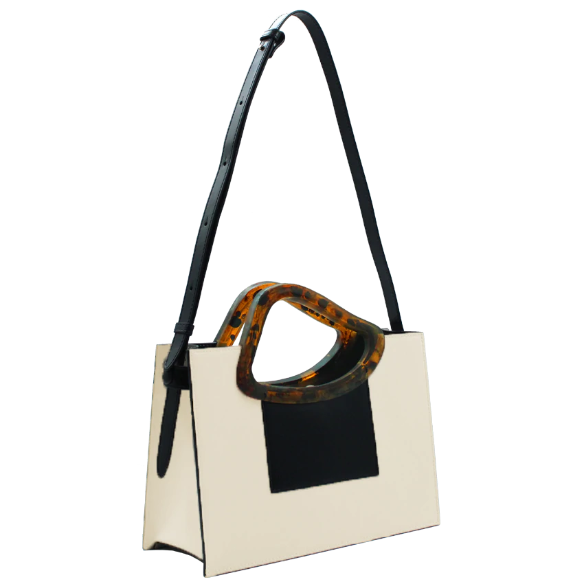 Beige black calf leather medium structured rectangle bag with bio resin handle and removable calf leather shoulder strap on a white stand