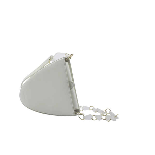 Flap topped oval structured white calf leather cross body bag with an adjustable leather and natural resin chain linked strap on a white stand