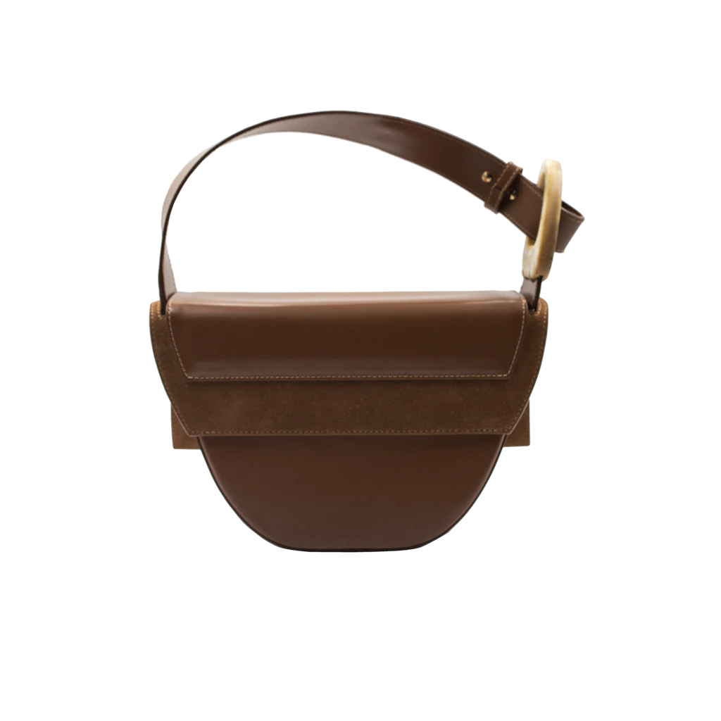 Rectangle shaped brown calf leather saddle bag with natural resin handle holder and remowable calf leather handle strap on a white stand