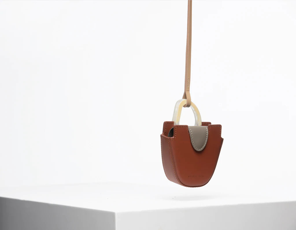 Mini flat topped oval structured retro brown calf leather tote bag with natural resin round handles and a removable adjustable calf leather strap.